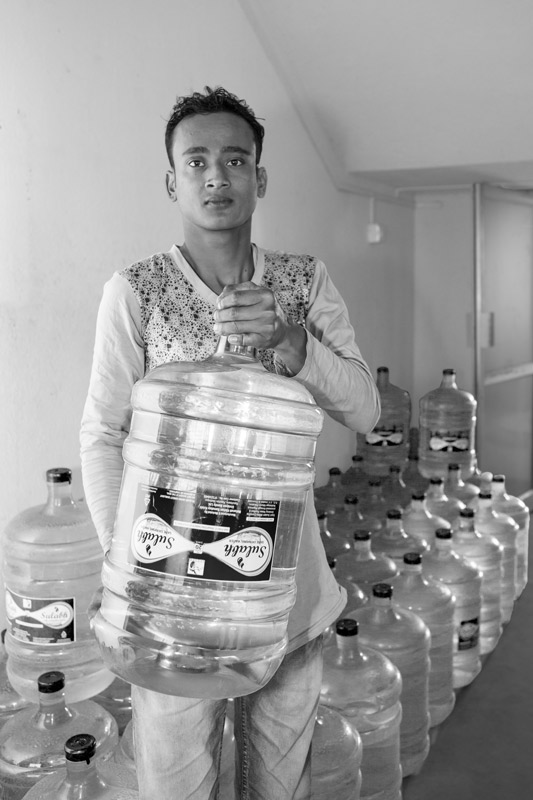 Leaving No One Behind: Human Right to Water in India - Carrying treated safe drinking water for home use after making a nominal payment in Paschim Medinipur district, West Bengal